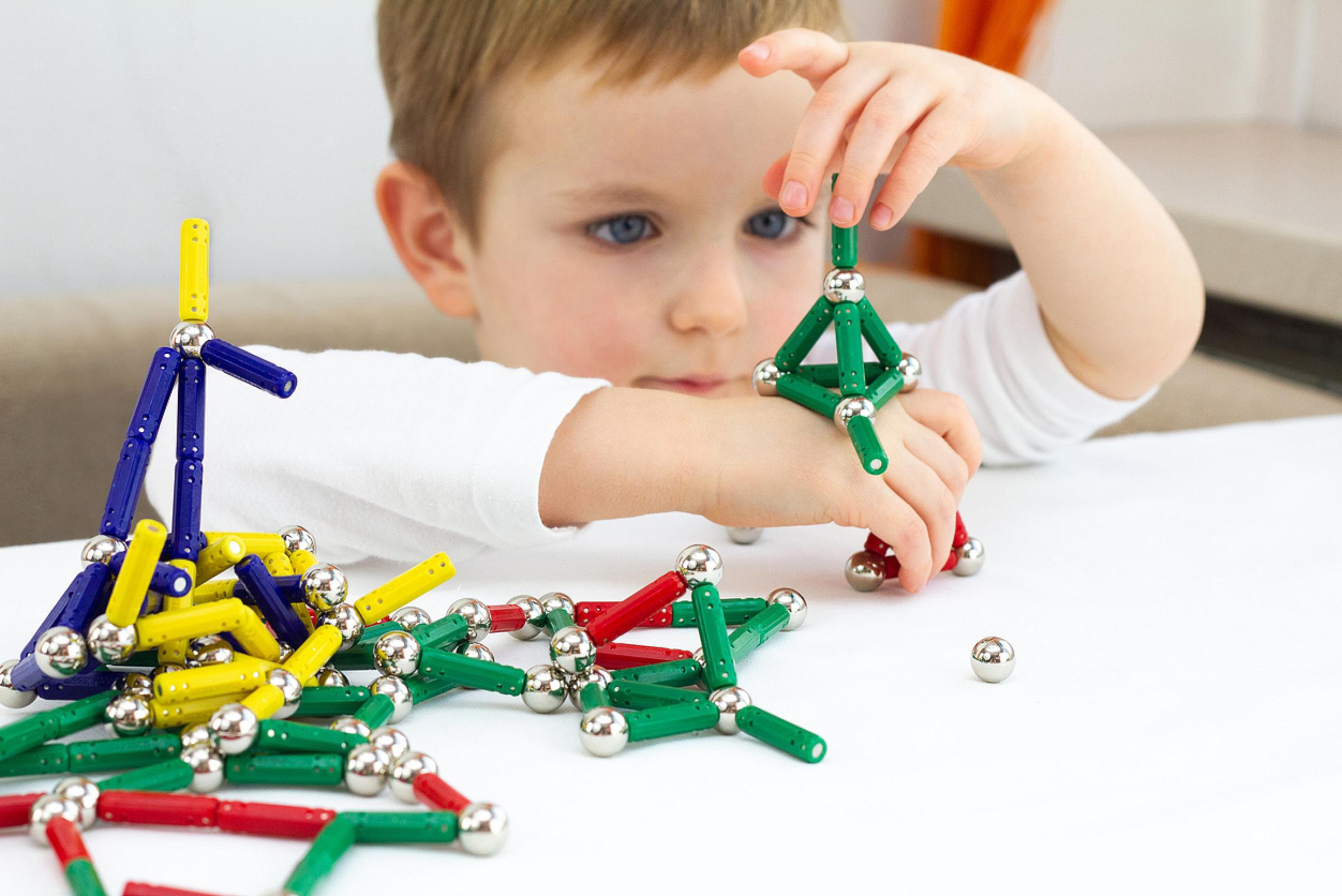 Child playing with toy magnets