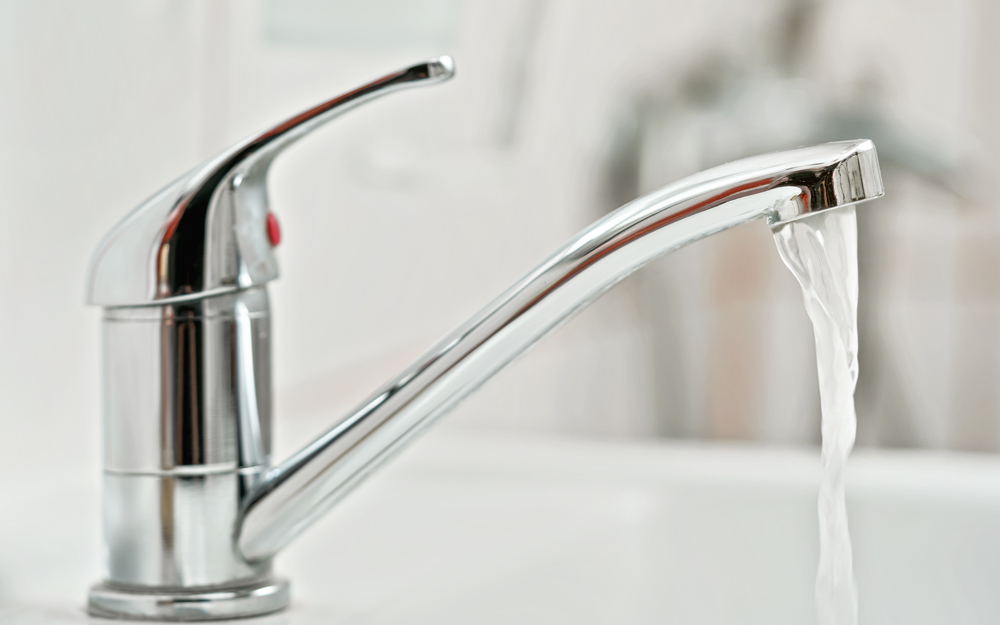 Faucet with running water in bathroom